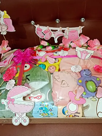 Another view of the pink-themed baby girl hamper, showing the variety of toys and clothes packed inside.