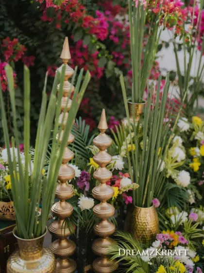 Close-up of the Haldi decor, showing traditional brass 'shikhar' elements mixed with fresh greenery and flowers.