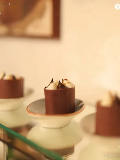 Miniature chocolate dessert cups, each one a perfect bite of indulgence. These are ideal for intimate gatherings where detail and quality are paramount.
