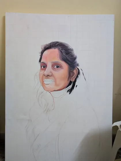Another view of a portrait in progress. This image shows the face partially rendered, highlighting the contrast between the sketched outline and the painted, lifelike features.