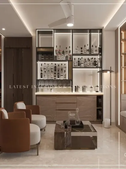 Another view of the integrated home bar and seating area, showcasing custom cabinetry with backlighting to display glassware. This is a perfect example of how I tailor spaces to a client's lifestyle.