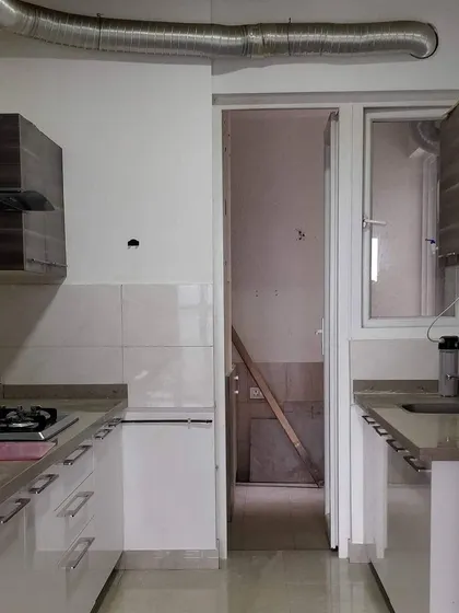 Before: This was a standard builder-grade galley kitchen. It was functional but lacked personality and felt disconnected from the adjoining utility area.