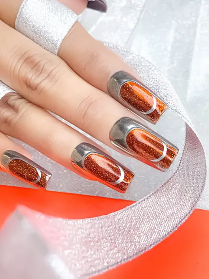 A stunning orange jelly nail set with a silver chrome frame. This design demonstrates the popular translucent jelly look combined with modern chrome accents.