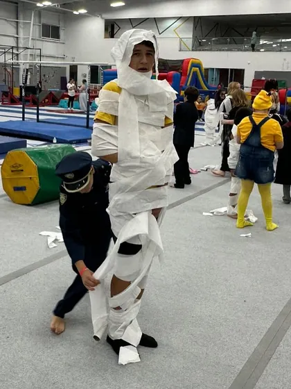 Kids work together to create the best mummy during our Spooktacular Friday Fun Night. This activity is always a huge hit and results in a lot of laughter.