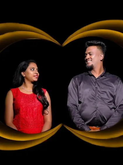 An artistic studio shot with a couple framed by golden light trails against a black background. This is a unique and creative take on a pre-wedding portrait.