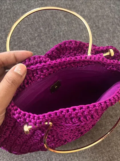 A peek inside the deep purple Rose Bag, showing the matching satin lining and the secure magnetic clasp.