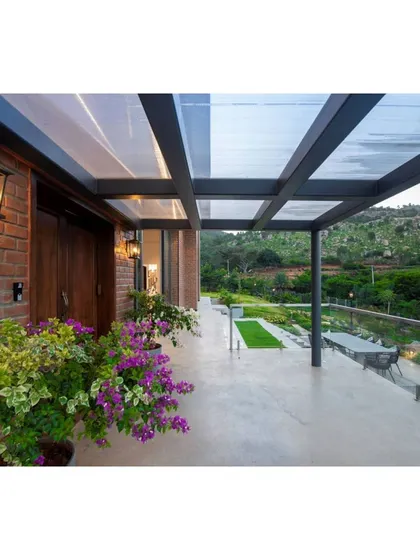 This is a duplicate of ID 74. The entrance to the Nandi Hills home features a warm combination of exposed brick and rich, dark wood.