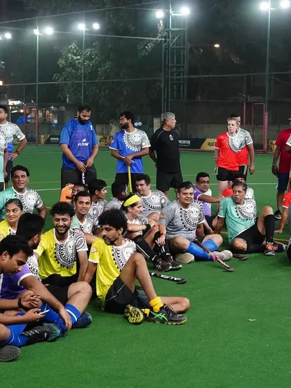 Players from different teams relax and chat on the turf after a game. These events foster a sense of community that extends beyond club rivalries.