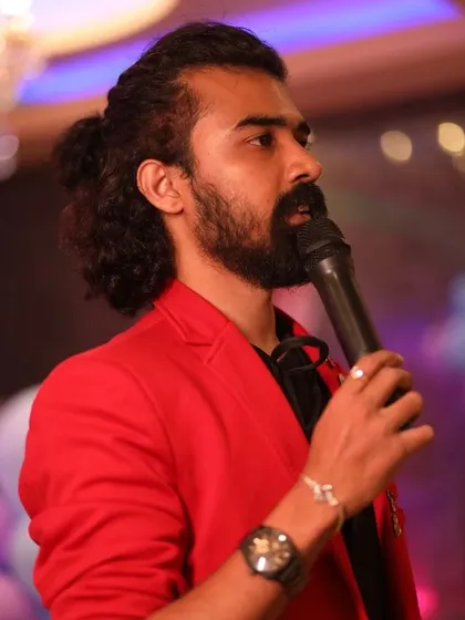 A close-up shot of me in a bright red jacket, focused on hosting and engaging with the audience.