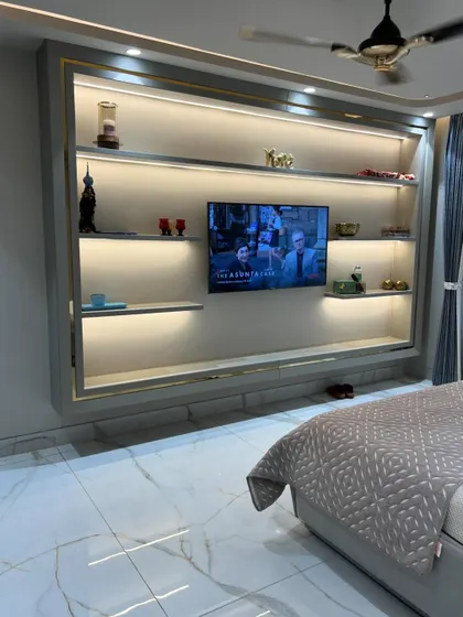 A wider shot of the bedroom, showing how the large media unit balances the space.