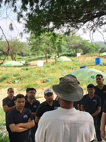 The Bacardi team listens intently as our expert explains the challenges facing Aravali Nagar Van, from waste contamination to the spread of invasive Prosopis Juliflora.