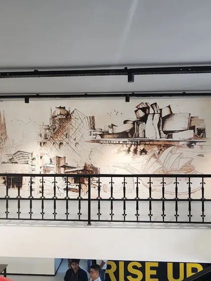 This mural at the Centrix office is a tribute to architectural geniuses. It's a montage of iconic structures by architects like Zaha Hadid, Frank Lloyd Wright, and Charles Correa, serving as daily inspiration for the design team.