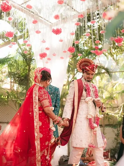 The bride and groom walking hand-in-hand towards the mandap, a symbolic start to their ceremony.