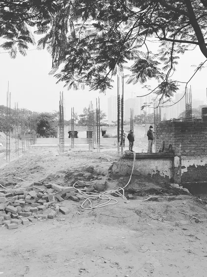 A site visit during the early stages of construction. Here, the foundation is being laid and the building's initial footprint is taking shape.