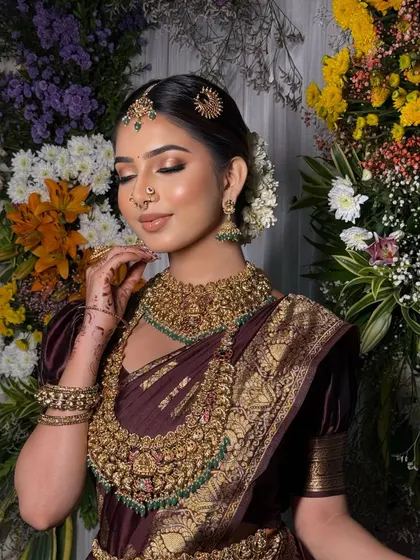 The bride looks serene and beautiful. The drape is soft and flattering, enhancing her natural grace.