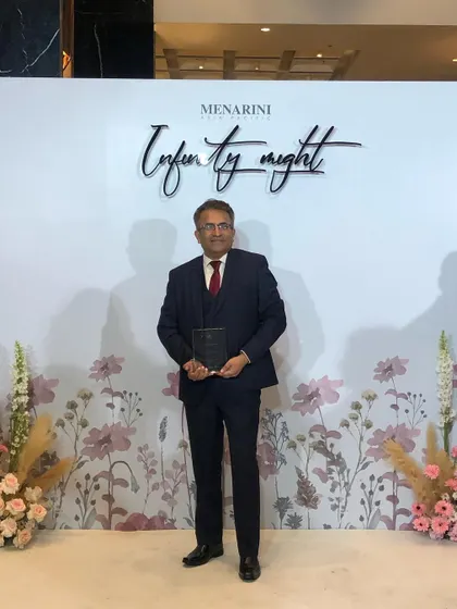 At the "Infinity Night" event in Bangkok, holding my faculty recognition award.