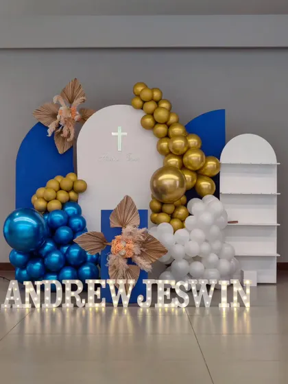 The full view of the modern Baptism setup. The layered backdrops and balloon garlands create a dynamic and visually appealing display.