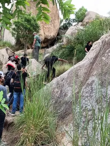 A group of guests navigates a rocky section of our trekking path. Our guided walks cater to various fitness levels and offer a safe way to explore the terrain.