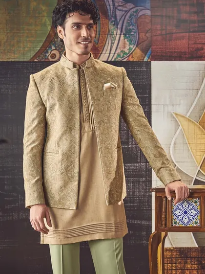 Impeccable craftsmanship meets timeless style. This layered look, featuring a beige jacket over a matching kurta, redefines the wardrobe for the modern man.