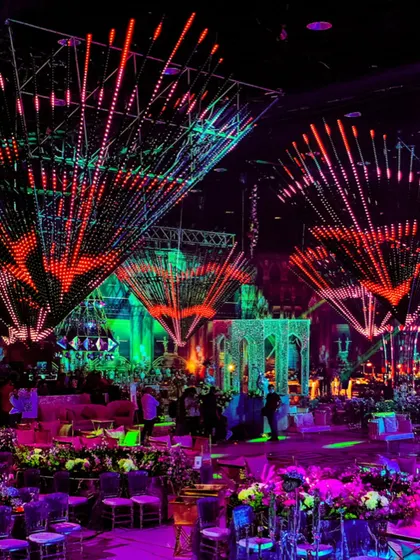 An electrifying Sangeet night with kinetic light installations. The dynamic red and green lights created a vibrant, pulsating energy that matched the excitement of the evening.