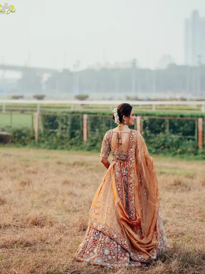 A breathtaking shot of the bride against an open field with the city in the distance. It’s a unique composition that blends nature with an urban landscape, creating a stunning and memorable bridal portrait.