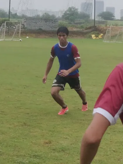 A player demonstrates intense focus during a one on one drill, preparing to take on a defender.