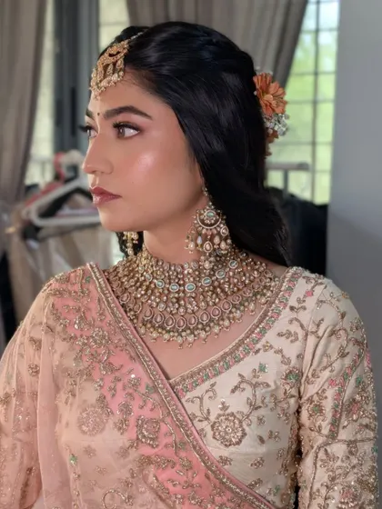 A side profile of Rashi's wedding hairstyle, showing the placement of the fresh flowers.