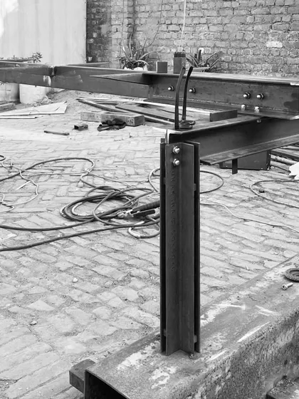 The structural steel base for a large table being fabricated. For a heavy tabletop, we believe in designing a robust structure, not just a simple frame, treating it as a piece of micro-architecture.
