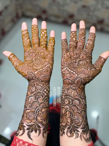 The complete bridal henna design on both hands. The symmetry and density of the pattern make it perfect for a bride's big day.