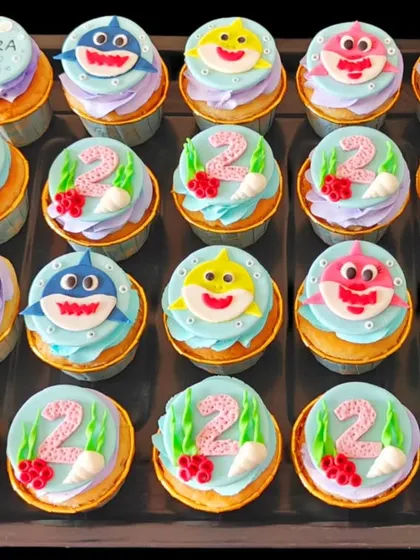 These Baby Shark cupcakes were a huge hit for a 2nd birthday. The set includes custom toppers with the birthday girl's name, age, and all the favorite shark characters.