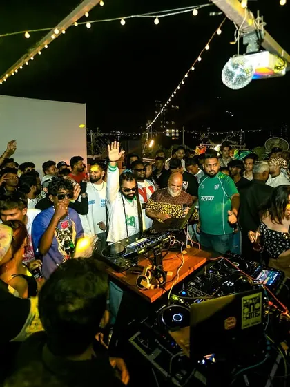 The whole crowd is engaged, hands in the air. This is the sign of a successful party.