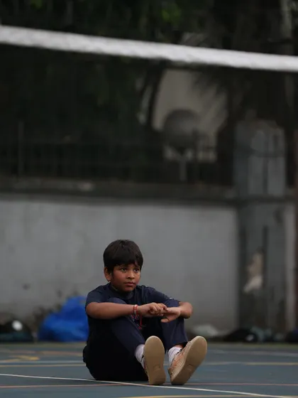 A young player sits and reflects after a drill. Even in quiet moments, the focus and love for the game are visible.
