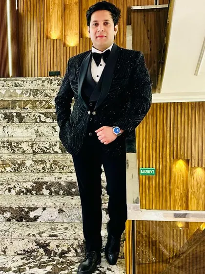 Our client looks absolutely stunning in this fully embellished black tuxedo. The intricate beadwork covers the entire jacket, creating a luxurious and celebratory look for a formal wedding event.