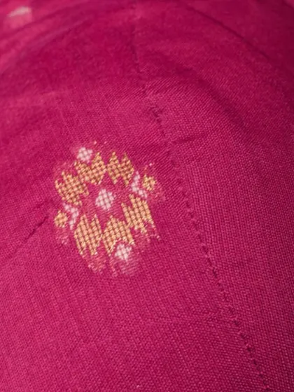 Another detail shot of a pink Jamdani cotton fabric, showing the delicate woven motifs. This fabric is lightweight, breathable, and incredibly artistic.