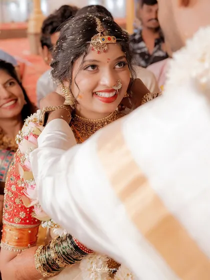 The bride’s radiant smile as the groom performs a ritual. Capturing this pure, uninhibited joy is what makes a wedding photograph truly timeless.