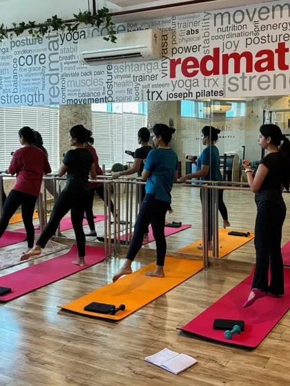 Our members work on their form at the barre, showcasing the collective energy and focus of our ActivBarre sessions.