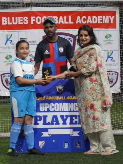 An "Upcoming Player" from our women's team receives her award. It's important to foster talent and potential in our female athletes.