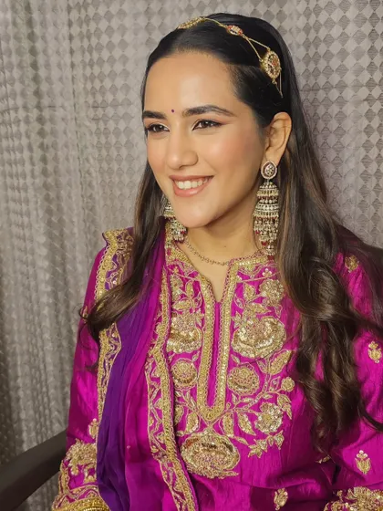 The lovely Khushi, all smiles in a vibrant magenta outfit. I kept her makeup fresh and radiant.