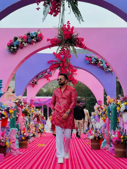 Walking down the aisle of a stunningly decorated pink-themed carnival. The visual grandeur of an event is the perfect canvas for the energy I bring.