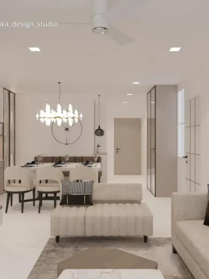 This living and dining space showcases a soft, monochromatic palette for a sophisticated and calming effect. The statement crystal chandelier over the dining table adds a touch of glamour, while the clean lines of the furniture and fluted sofa base maintain a modern feel.