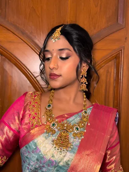 A soft, glowing look for this South Indian bride. The makeup is kept elegant and understated to let the stunning jewelry and saree take center stage.