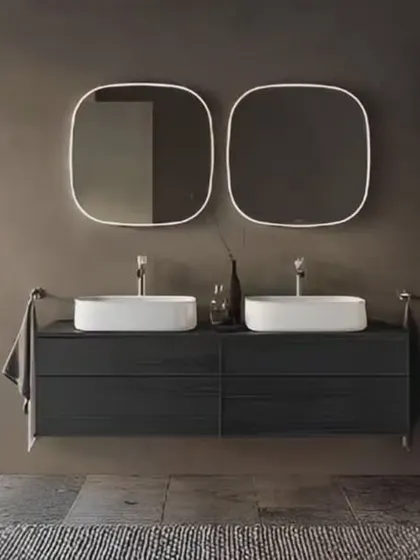 A sleek and modern bathroom with a floating double vanity in dark wood. The twin squared mirrors with rounded corners and white vessel sinks create a clean, symmetrical look.