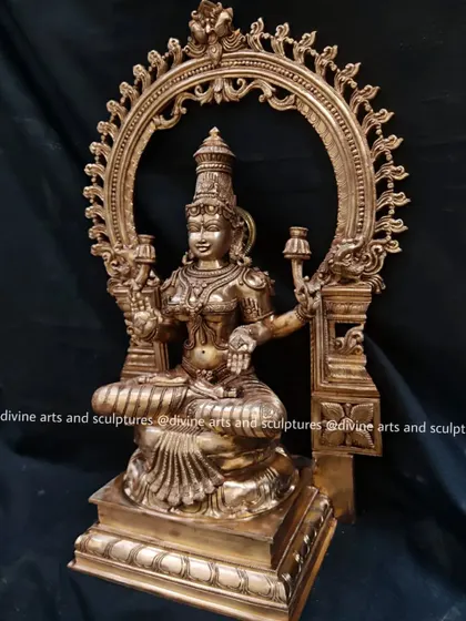 A side view of the MahaLakshmi sculpture, showing the depth of the throne and the intricate details of the Makara (mythical creature) carvings on the Prabhavali.