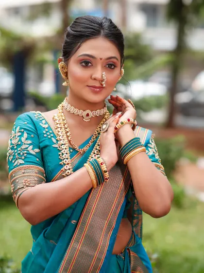 The model posing to show the full effect of the makeup and accessories.