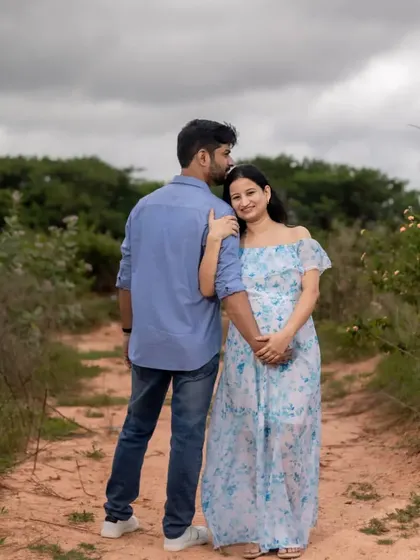 A serene outdoor maternity photo of a couple on a country path. This shot captures a quiet, reflective moment together in nature as they look forward to their new chapter.