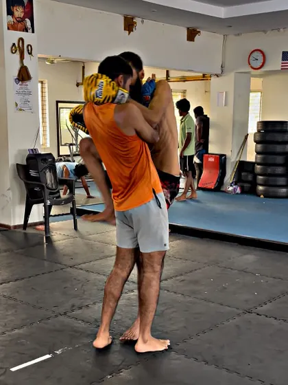 A student practices a clinch and knee strike during a sparring session. This is how we apply our techniques against a resisting partner.