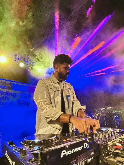 A close-up shot of me mixing under the stage lights at IIM Kozhikode. This shows my focus and technical skill in action, even amidst the high energy of a festival.