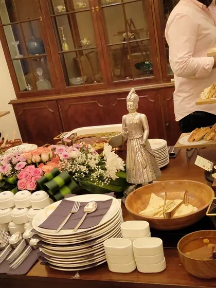 A member of my team arranging sandwiches on a tiered stand for a high-tea party. I handle all the details so you can enjoy the party with your guests.