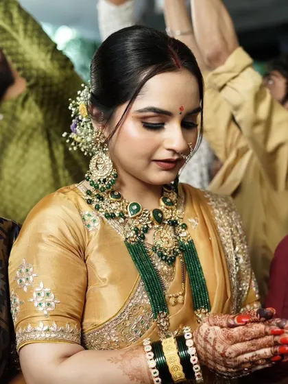 A candid moment during the ceremony. The makeup is flawless and respectful of the traditional setting.