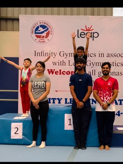 Our coaches stand proudly with our champion on the podium. Their expertise and support are vital to our students' success.